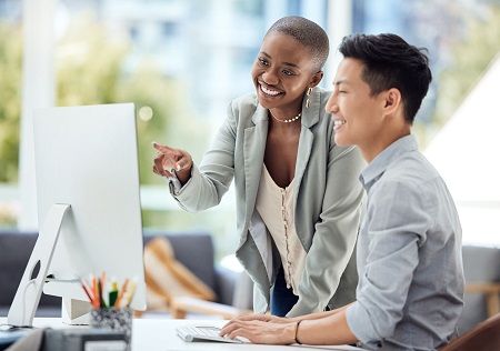 woman and man looking at computer